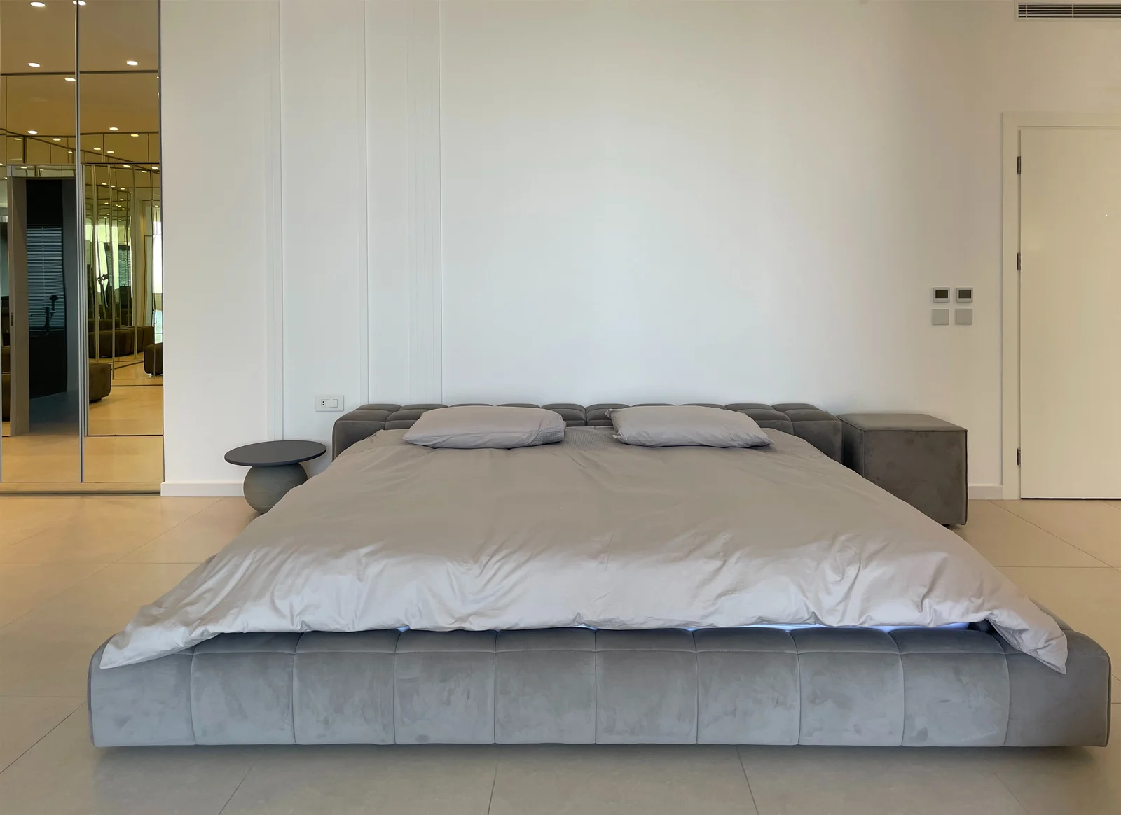 Upholstered bed & panelled wall