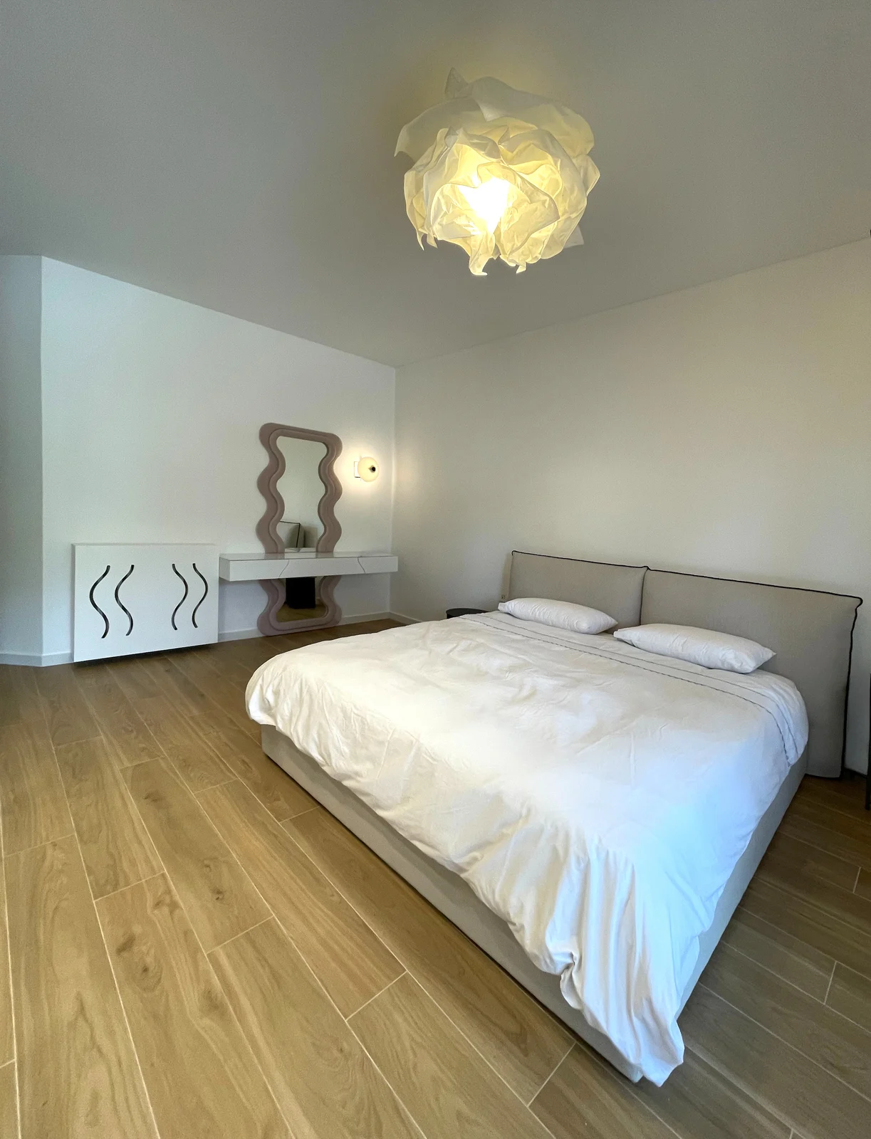 Bedroom with sculpted mirror