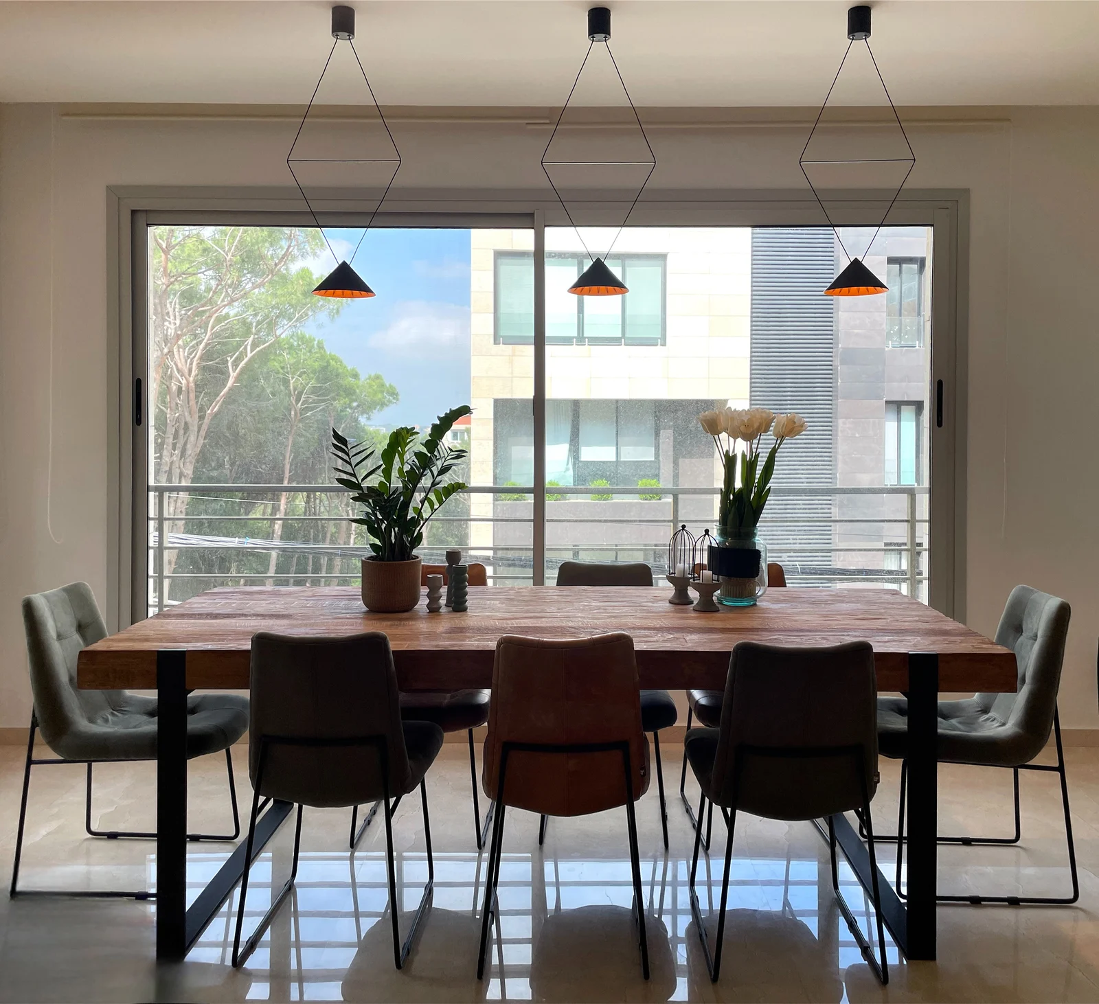Dining area with geometric pendants