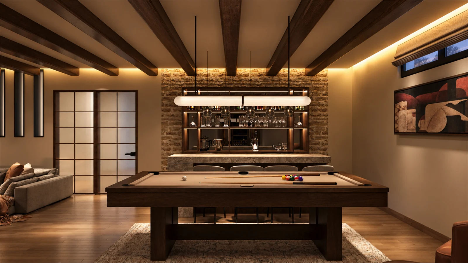 Pool table beneath a linear pendant facing the stone-backed bar